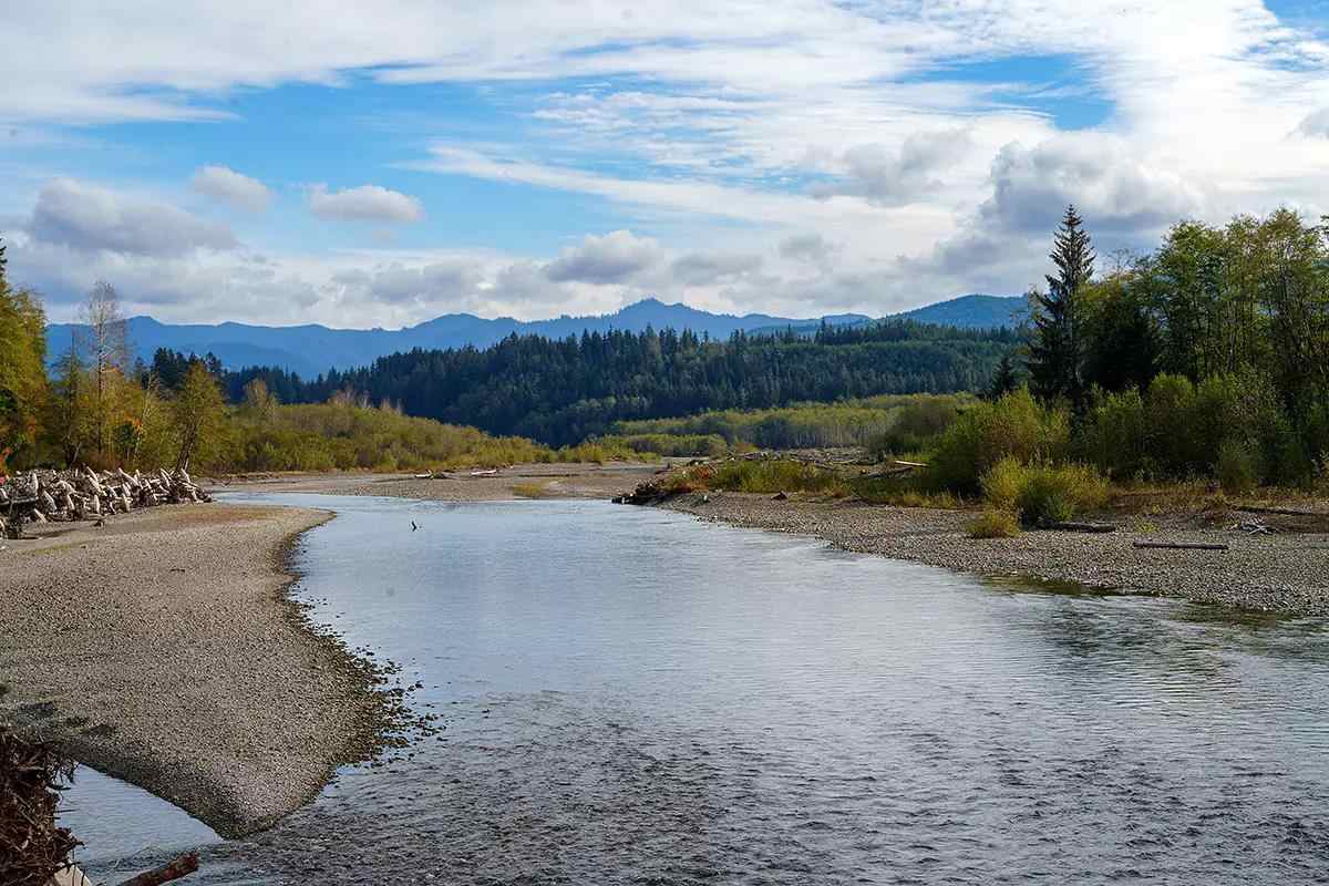 A river flowing very low with mountains in the background.