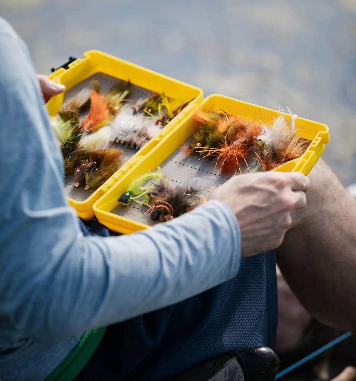 A streamer fly box opened and being gazed upon.