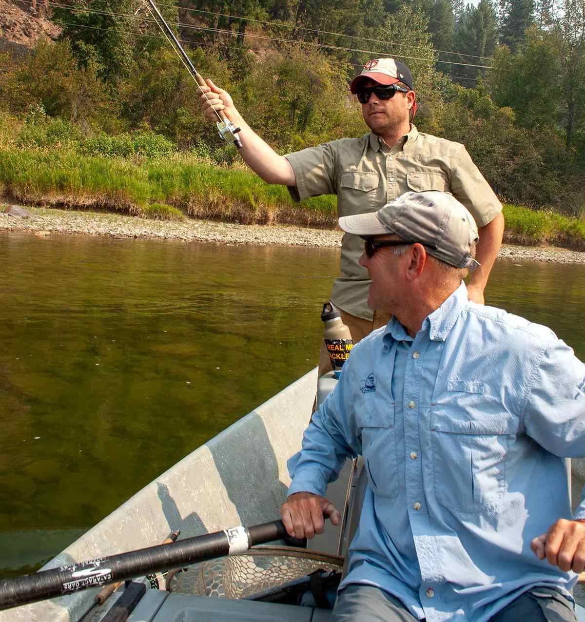 A fishing and client in a drift boat.