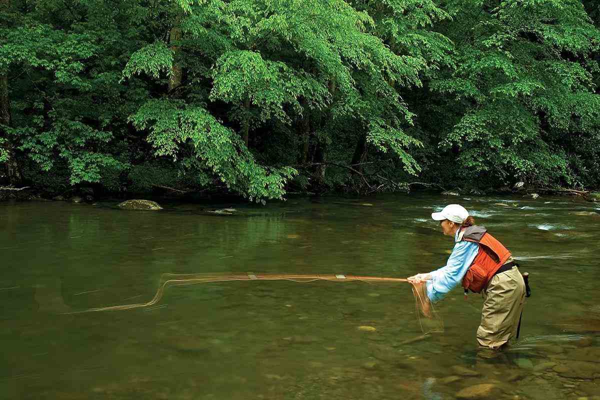 A woman fly fishing in Great Smoky Mountains National Park. 